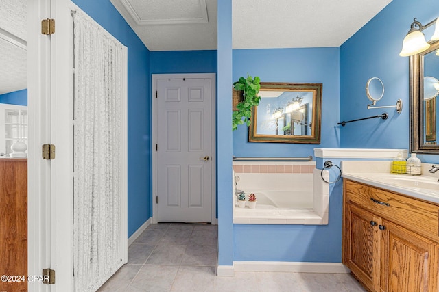 bathroom with a bathtub, a textured ceiling, vanity, and tile flooring