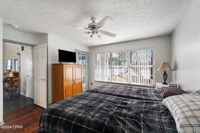 tiled bedroom featuring a textured ceiling and ceiling fan