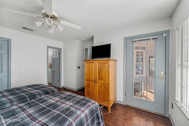 bedroom featuring a textured ceiling, ceiling fan, and dark wood-type flooring