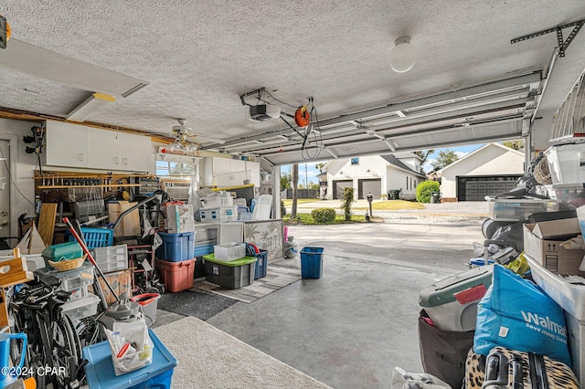 garage featuring ceiling fan and a garage door opener