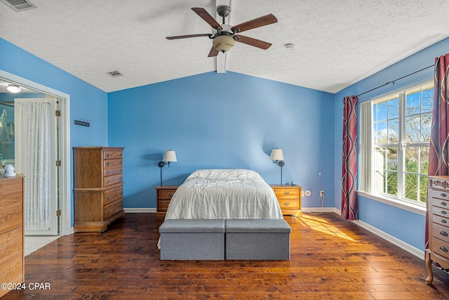 bedroom with ceiling fan, a textured ceiling, dark wood-type flooring, and vaulted ceiling