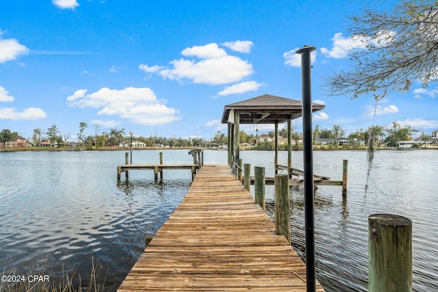 view of dock featuring a gazebo and a water view