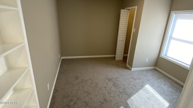 unfurnished room with plenty of natural light and light carpet