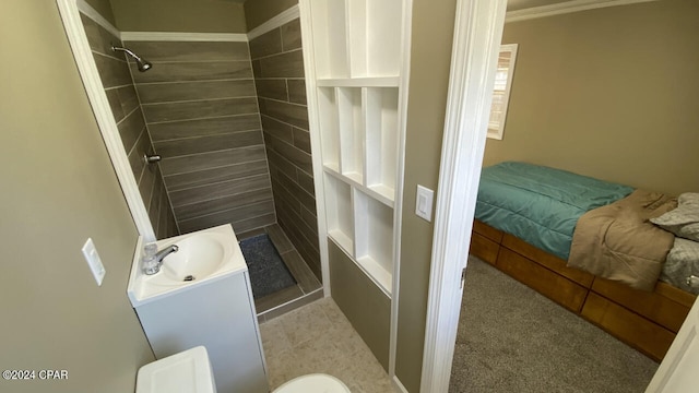 bathroom with vanity, tile floors, crown molding, and a shower