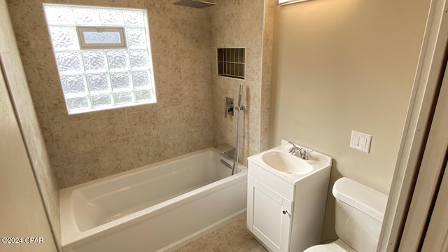 full bathroom with vanity, toilet, and tiled shower / bath