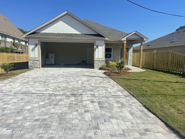 view of front of property with a front yard and a garage