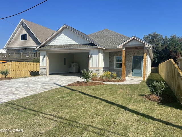 view of front of property with a front yard and a carport