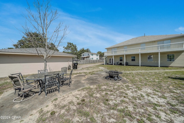 view of yard with an outdoor fire pit and a patio