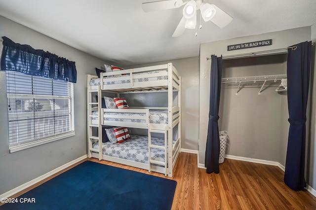 bedroom featuring ceiling fan, a closet, and hardwood / wood-style flooring