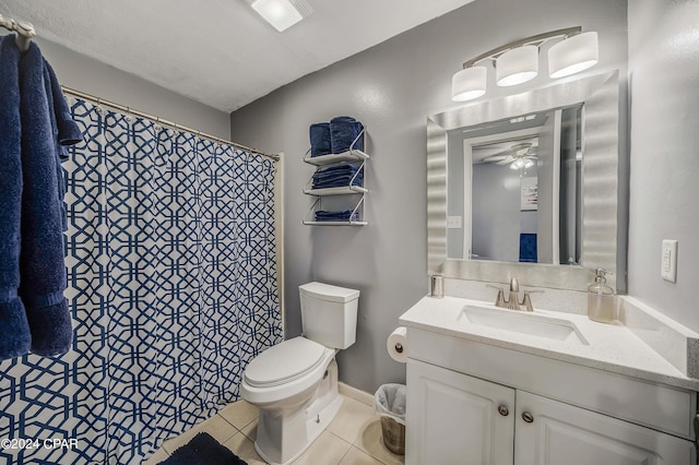 bathroom with tile patterned floors, toilet, vanity, ceiling fan, and a textured ceiling