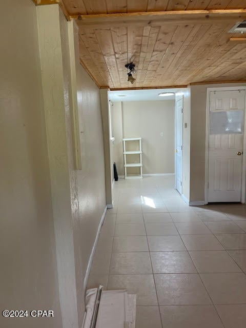 corridor featuring wooden ceiling and light tile patterned floors