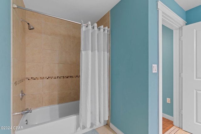 bathroom featuring tile floors and shower / tub combo with curtain