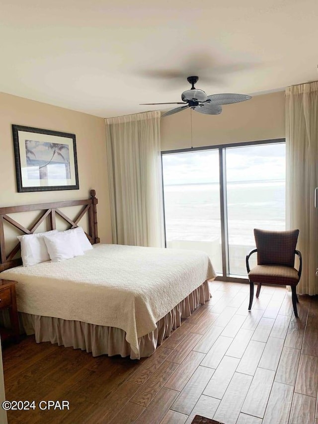 bedroom with hardwood / wood-style floors, ceiling fan, and access to outside