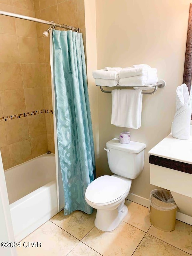 bathroom featuring shower / bath combo with shower curtain, toilet, and tile flooring