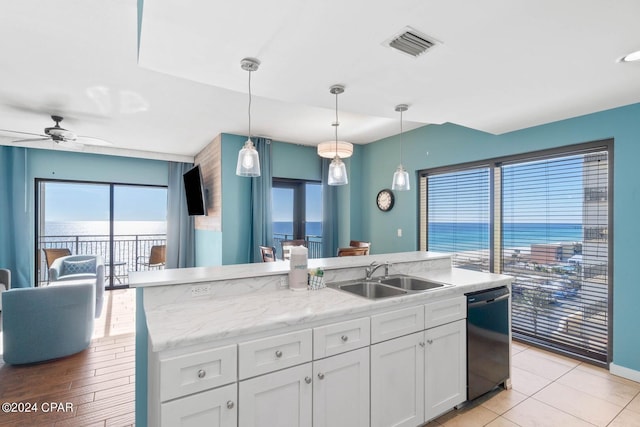 kitchen featuring pendant lighting, ceiling fan, sink, black dishwasher, and white cabinetry