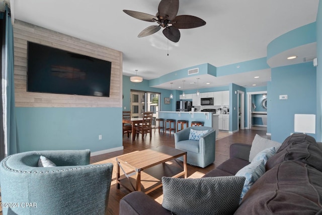 living room featuring ceiling fan and light wood-type flooring