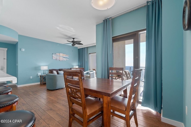 dining space with dark hardwood / wood-style floors and ceiling fan