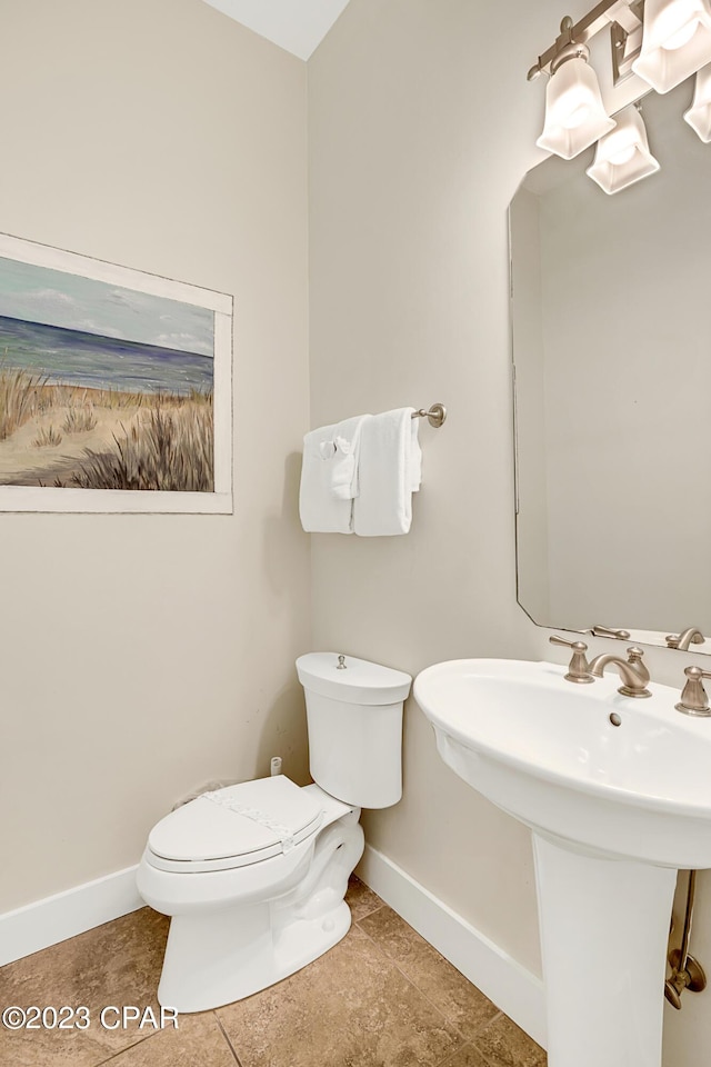 bathroom featuring tile patterned flooring and toilet