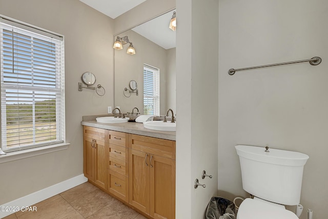 bathroom with tile patterned floors, vanity, and toilet