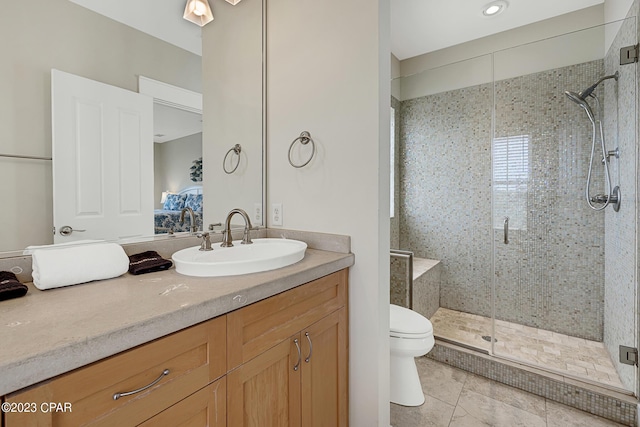 bathroom with vanity, toilet, and a shower with shower door