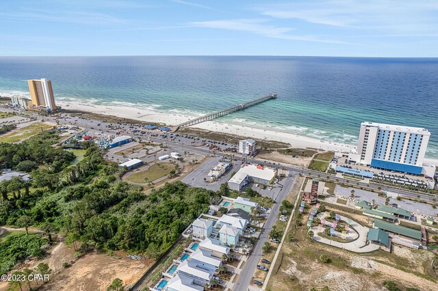 drone / aerial view featuring a water view and a view of the beach