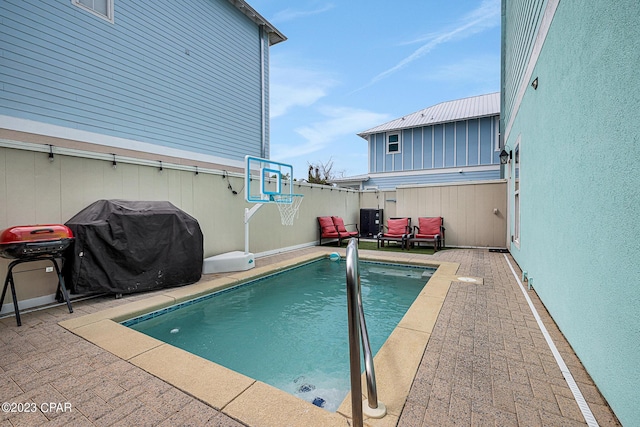 view of pool featuring grilling area