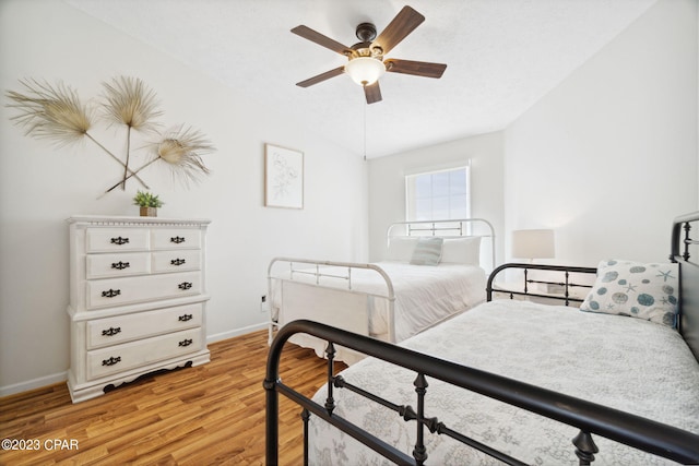 bedroom featuring ceiling fan, lofted ceiling, and light hardwood / wood-style floors