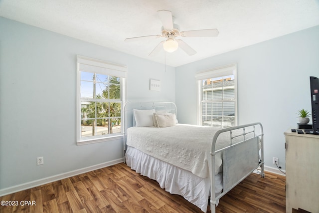 bedroom with dark wood-type flooring and ceiling fan