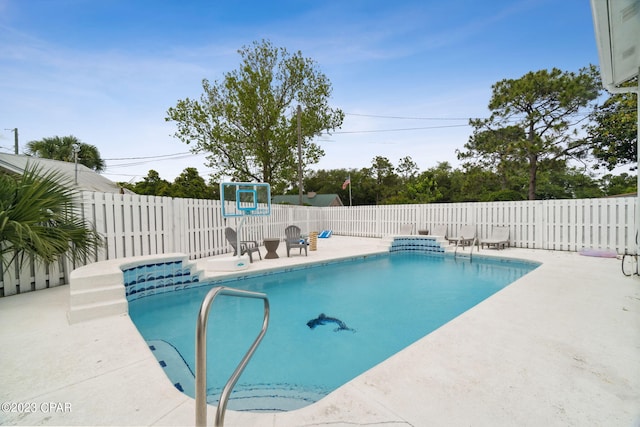 view of swimming pool featuring a patio