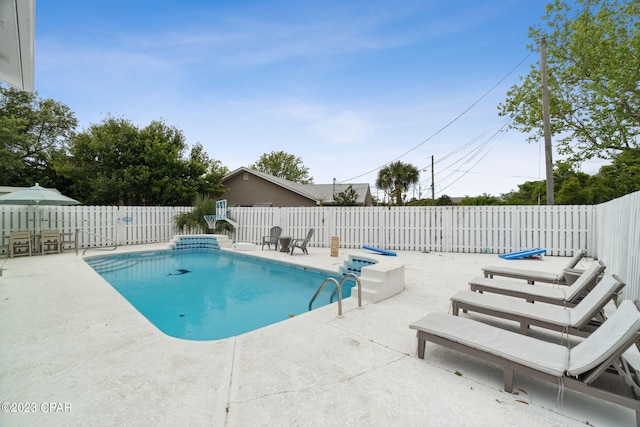 view of swimming pool with a patio area