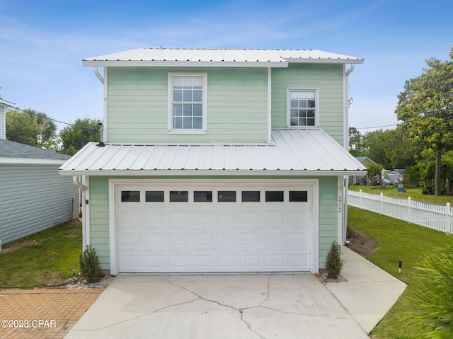 view of front of house featuring a front yard and a garage