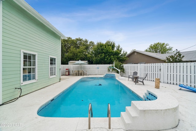 view of swimming pool featuring a patio area