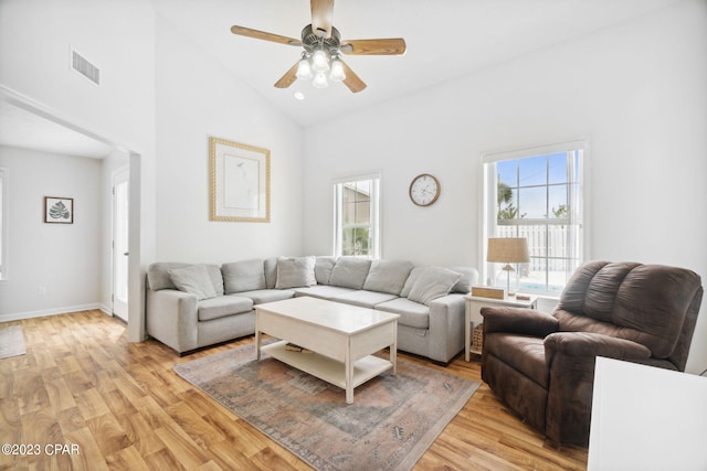 living room with ceiling fan, high vaulted ceiling, and light hardwood / wood-style floors