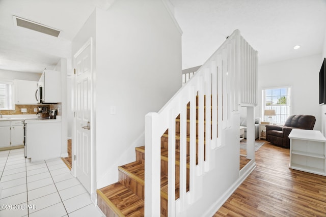 stairway featuring tile patterned flooring