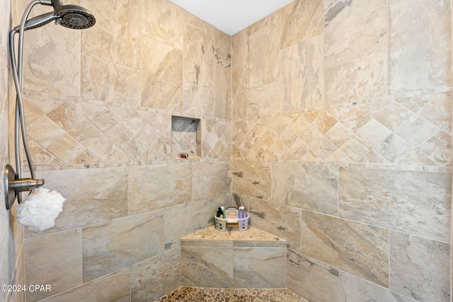 bathroom with tiled shower