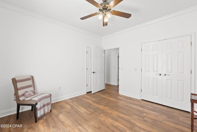 living area with ornamental molding, dark hardwood / wood-style flooring, and ceiling fan