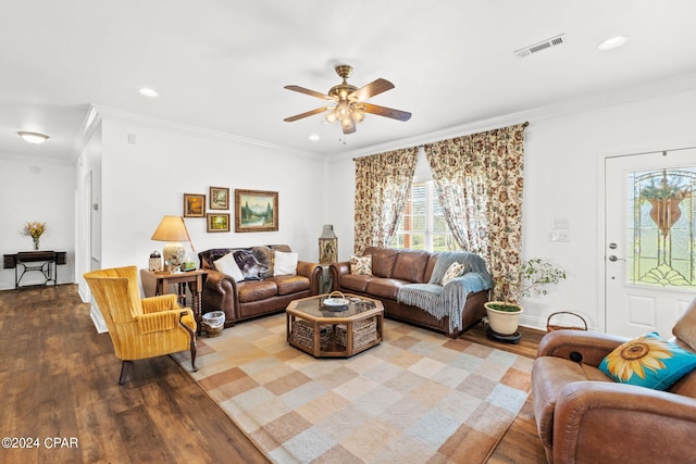 living room featuring ornamental molding, ceiling fan, and light wood-type flooring