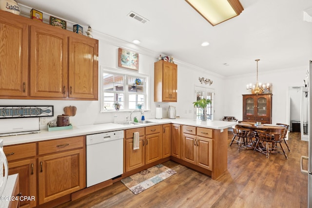 kitchen with an inviting chandelier, dark hardwood / wood-style flooring, a wealth of natural light, and dishwasher