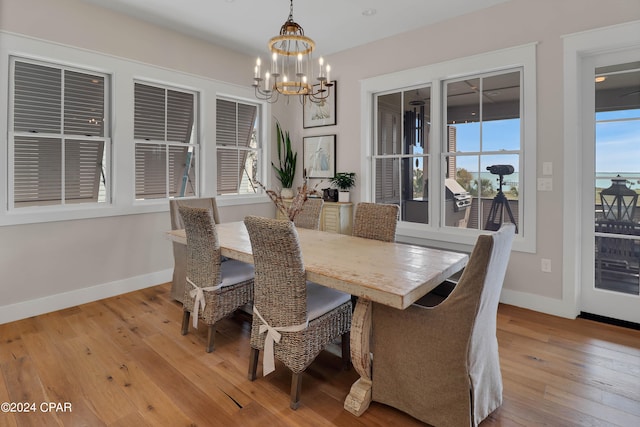 dining space with a notable chandelier and light wood-type flooring