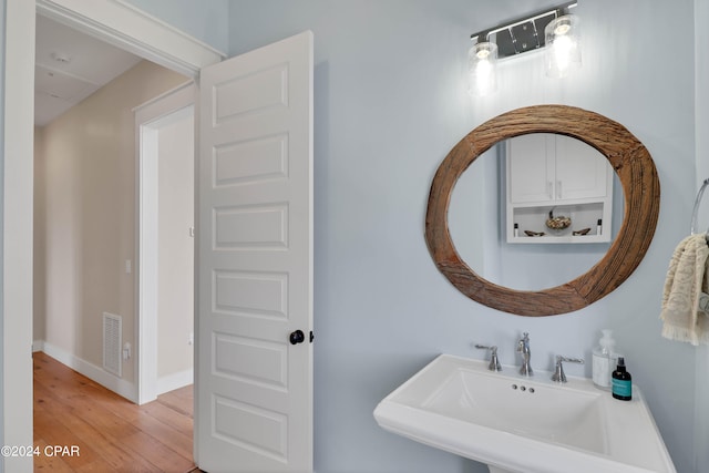 bathroom with hardwood / wood-style floors and sink