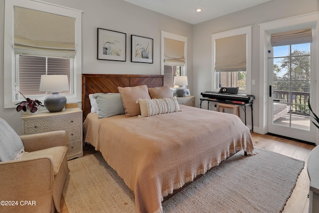 bedroom featuring light hardwood / wood-style floors and access to exterior