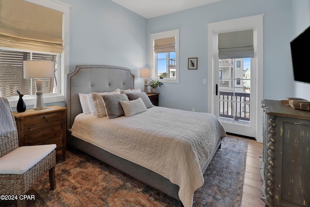 bedroom with dark hardwood / wood-style flooring and access to exterior