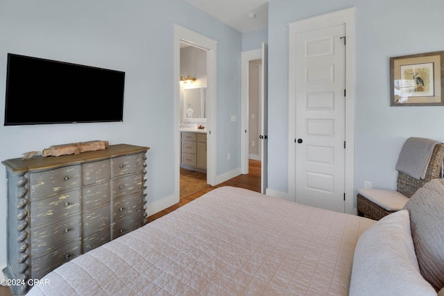 tiled bedroom featuring connected bathroom