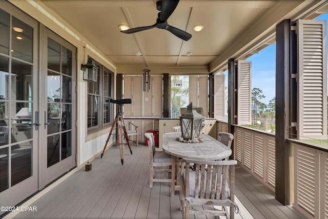 sunroom featuring ceiling fan and french doors