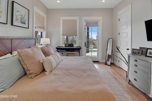 bedroom with access to exterior and light wood-type flooring