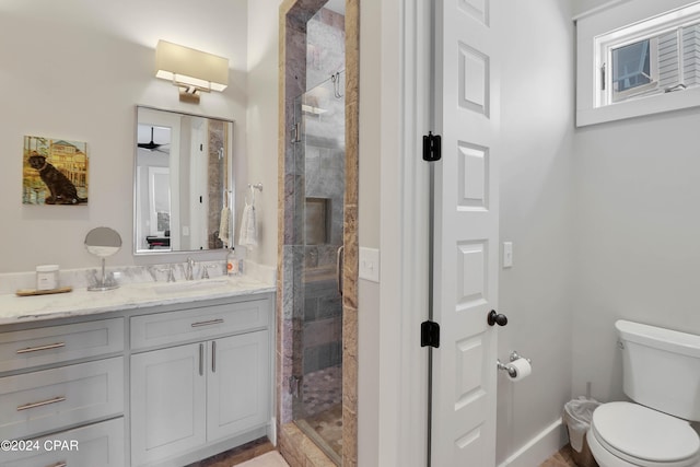 bathroom featuring toilet, walk in shower, and vanity