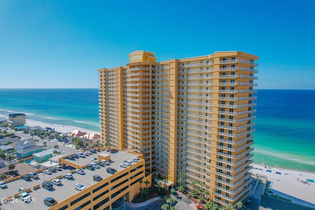 exterior space with a water view and a beach view