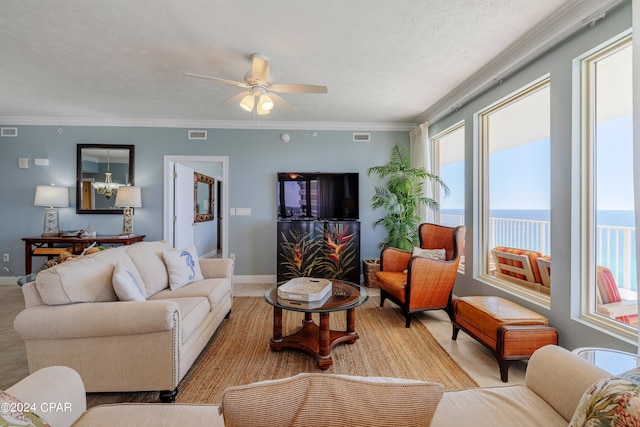 living room featuring a water view, ornamental molding, a healthy amount of sunlight, and ceiling fan