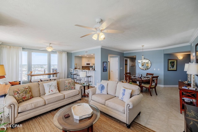 living room featuring light tile floors, a textured ceiling, crown molding, and ceiling fan