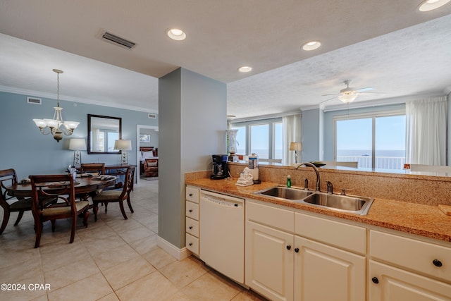 kitchen with white dishwasher, plenty of natural light, ceiling fan with notable chandelier, and sink